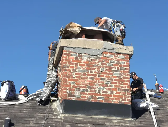 Rehoboth Chimney Sweep installing a custom chimney crown in Rehoboth, MA